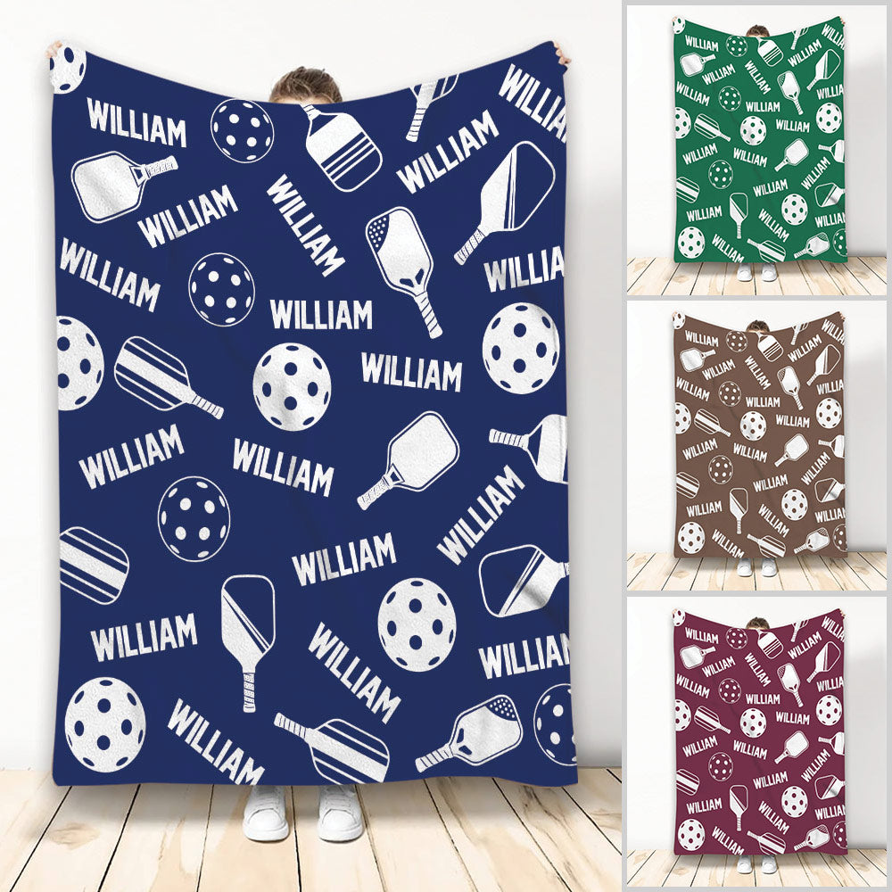 Navy pickleball throw blanket with paddle and perforated ball artwork in a repeating sports design