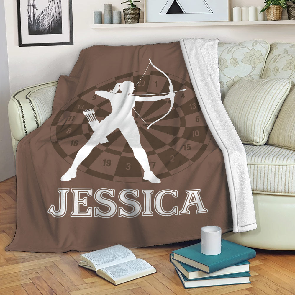 Archery blanket draped over a sofa with archer silhouette and target-inspired design