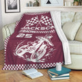 Maroon motocross blanket draped on a sofa with dirt bike racing artwork