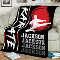 Karate throw blanket draped over a couch with kicking martial artist silhouette and dramatic red design
