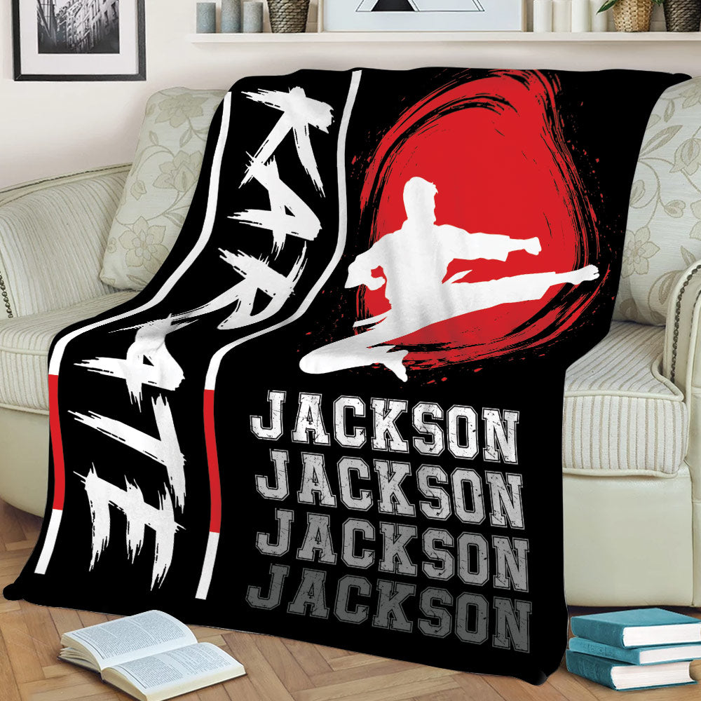 Karate throw blanket draped over a couch with kicking martial artist silhouette and dramatic red design