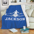 Blue rowing throw blanket draped over a sofa with white rower and water artwork