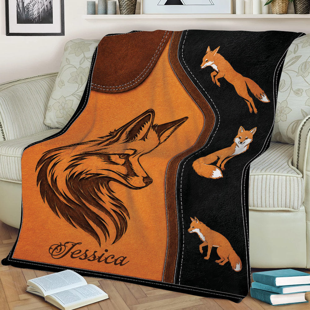 Rustic fox throw blanket draped over a couch with detailed orange fox illustrations