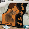 Russian Blue cat throw blanket displayed on a sofa with warm brown and black artwork
