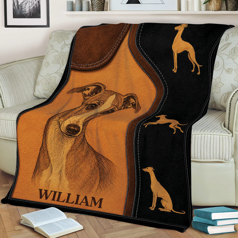Whippet blanket draped over a sofa, featuring a detailed dog illustration and decorative Whippet silhouettes