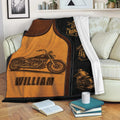 Biker throw blanket draped over a sofa with motorcycle illustrations and bold black and amber artwork