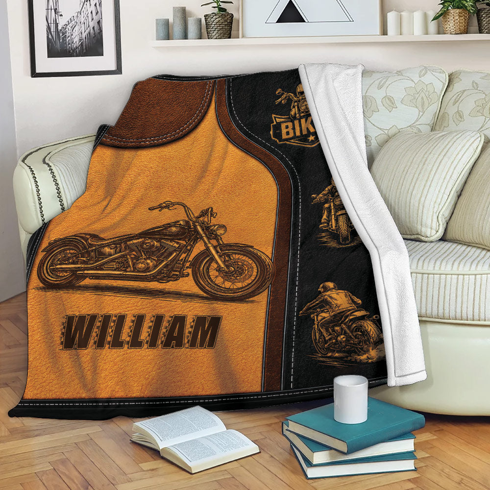 Biker throw blanket draped over a sofa with motorcycle illustrations and bold black and amber artwork