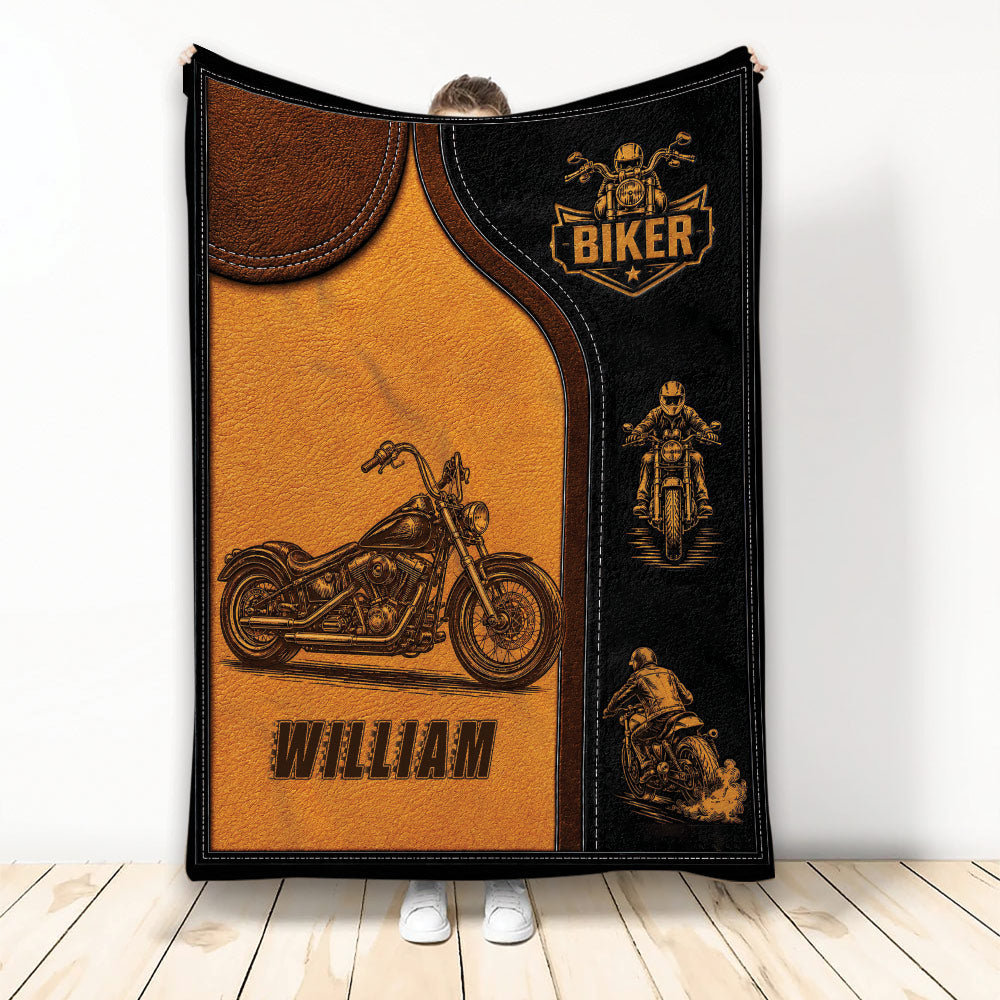 Biker throw blanket held upright with vintage motorcycle artwork and black and amber leather-look design
