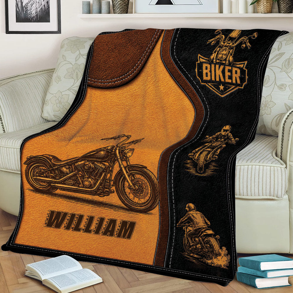 Motorcycle biker blanket displayed on a couch with vintage rider illustrations and leather-look styling