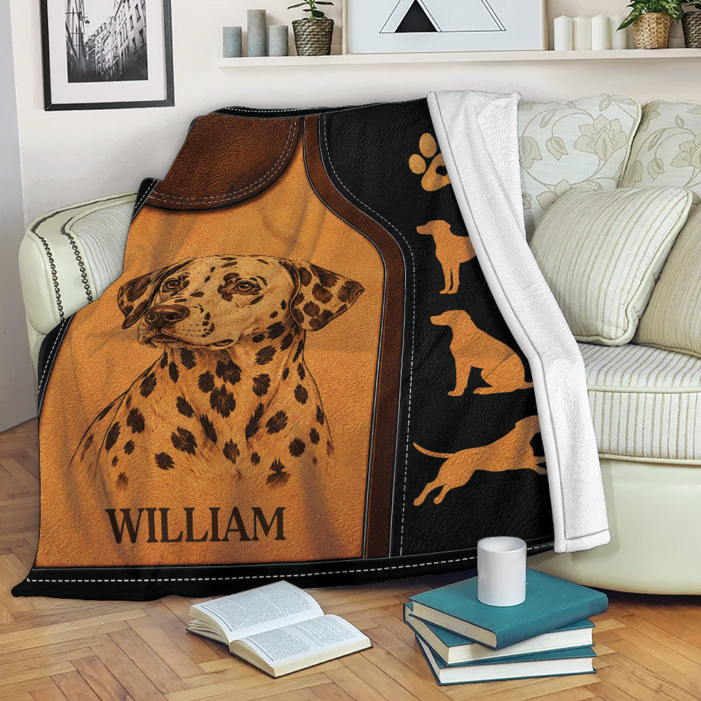Dalmatian throw blanket draped over a sofa with spotted dog portrait and coordinating dog silhouette border