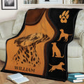 Dalmatian blanket displayed on a couch with detailed spotted dog artwork, paw print, and warm leather-look colors