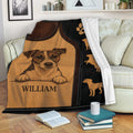 Jack Russell throw blanket displayed on a sofa with brown leather-look dog artwork and black accents
