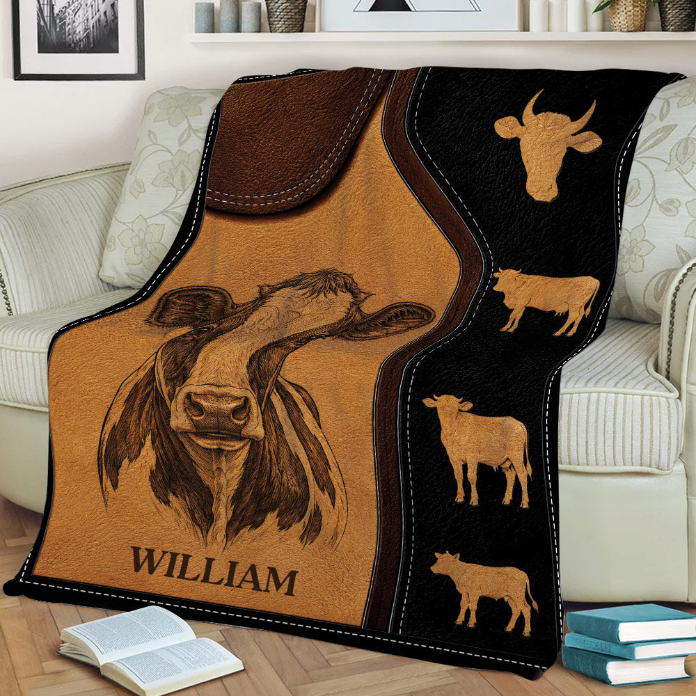 Rustic cow blanket displayed on a couch with detailed central cow and cattle silhouettes