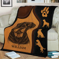 Rottweiler throw blanket displayed on a couch with detailed portrait artwork and dog silhouettes