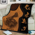 Custom mermaid throw blanket displayed on a couch with vintage ocean artwork and warm sepia tones