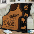 Custom Pug throw blanket draped over a sofa with paw print and multiple pug silhouettes