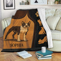 Boston Terrier blanket displayed on a sofa with leather-look artwork and decorative dog silhouettes