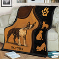 Boston Terrier throw blanket draped over a couch, featuring illustrated dog artwork and black and brown styling
