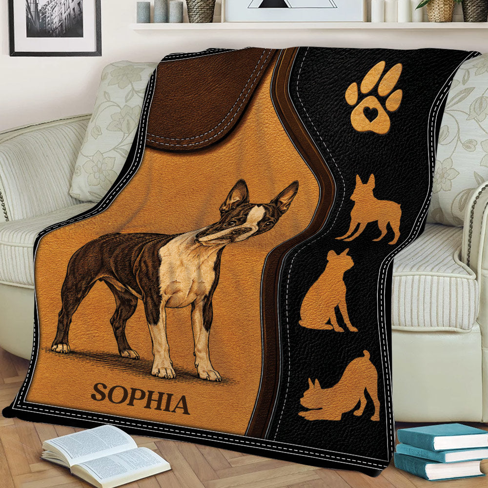 Boston Terrier throw blanket draped over a couch, featuring illustrated dog artwork and black and brown styling