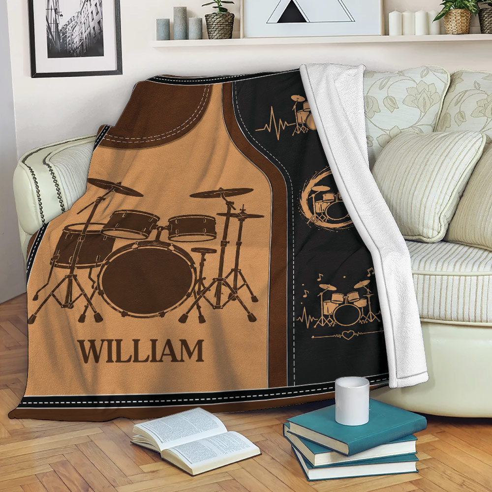 Drum throw blanket displayed across a sofa with vintage music artwork