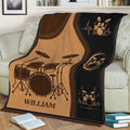 Drum blanket draped over a couch featuring drum kits, musical notes and heartbeat lines
