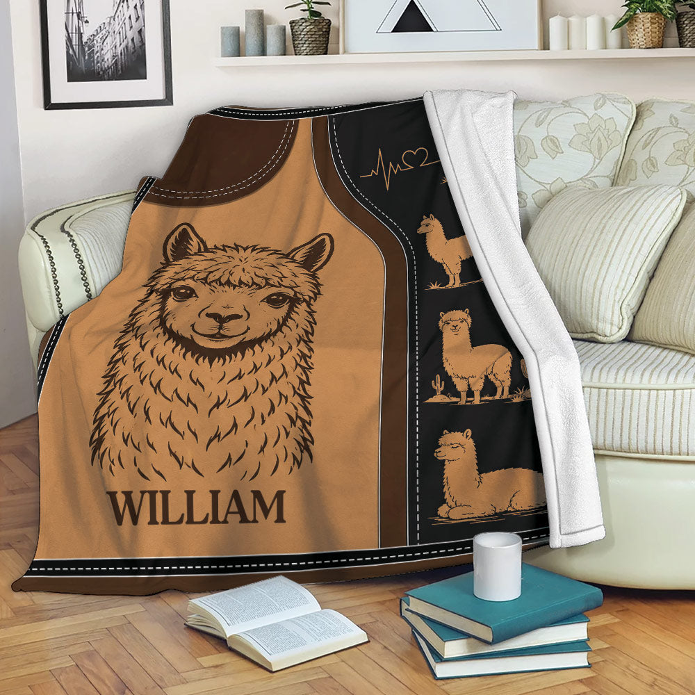 Alpaca throw blanket draped over a sofa, featuring cozy brown alpaca artwork and decorative illustrations
