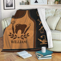 Dentist blanket displayed on a sofa with tooth and dental instrument artwork in brown and black