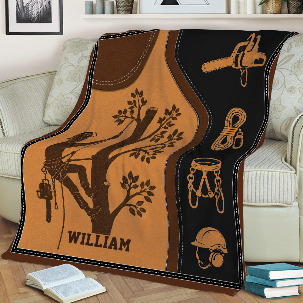 Tree climber arborist throw blanket displayed on a couch with chainsaw, rope and harness illustrations
