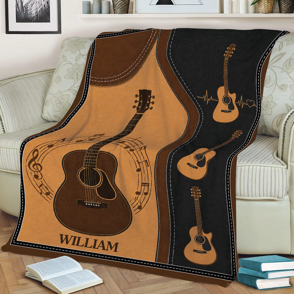 Acoustic guitar throw blanket draped over a couch with warm wood tones and music-themed artwork
