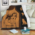 Husky throw blanket draped over a sofa, featuring warm brown dog artwork and paw details