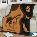Husky blanket displayed on a couch with vintage dog illustrations and a black paw-print panel