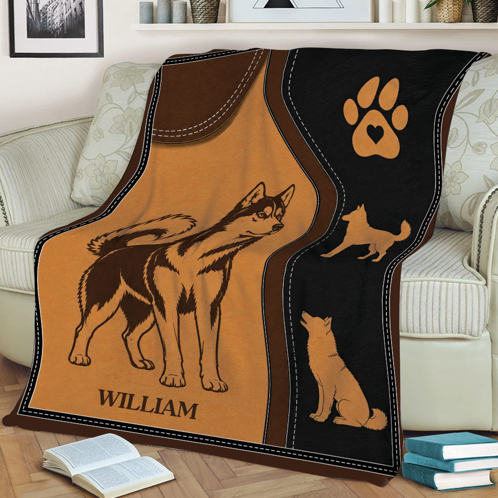 Husky blanket displayed on a couch with vintage dog illustrations and a black paw-print panel