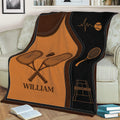 Tennis throw blanket displayed on a couch with crossed racquets and bold orange court-themed artwork