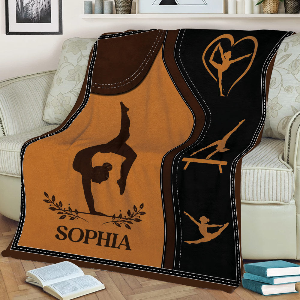 Gymnastics throw blanket displayed on a couch with artistic athlete silhouettes and warm brown tones