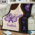 Purple Alzheimer's awareness blanket draped over a couch with butterfly, brain, and ribbon symbols