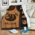 Sloth throw blanket draped over a sofa with warm brown artwork and repeating sloth illustrations