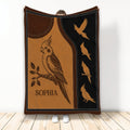 Cockatiel throw blanket displayed upright with sepia bird artwork, branch illustration, and repeating flying cockatiels