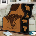 Decorative elephant throw blanket displayed on a sofa with brown and black wildlife artwork