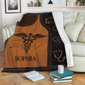 Nursing throw blanket displayed on a sofa with medical symbols and warm brown artwork
