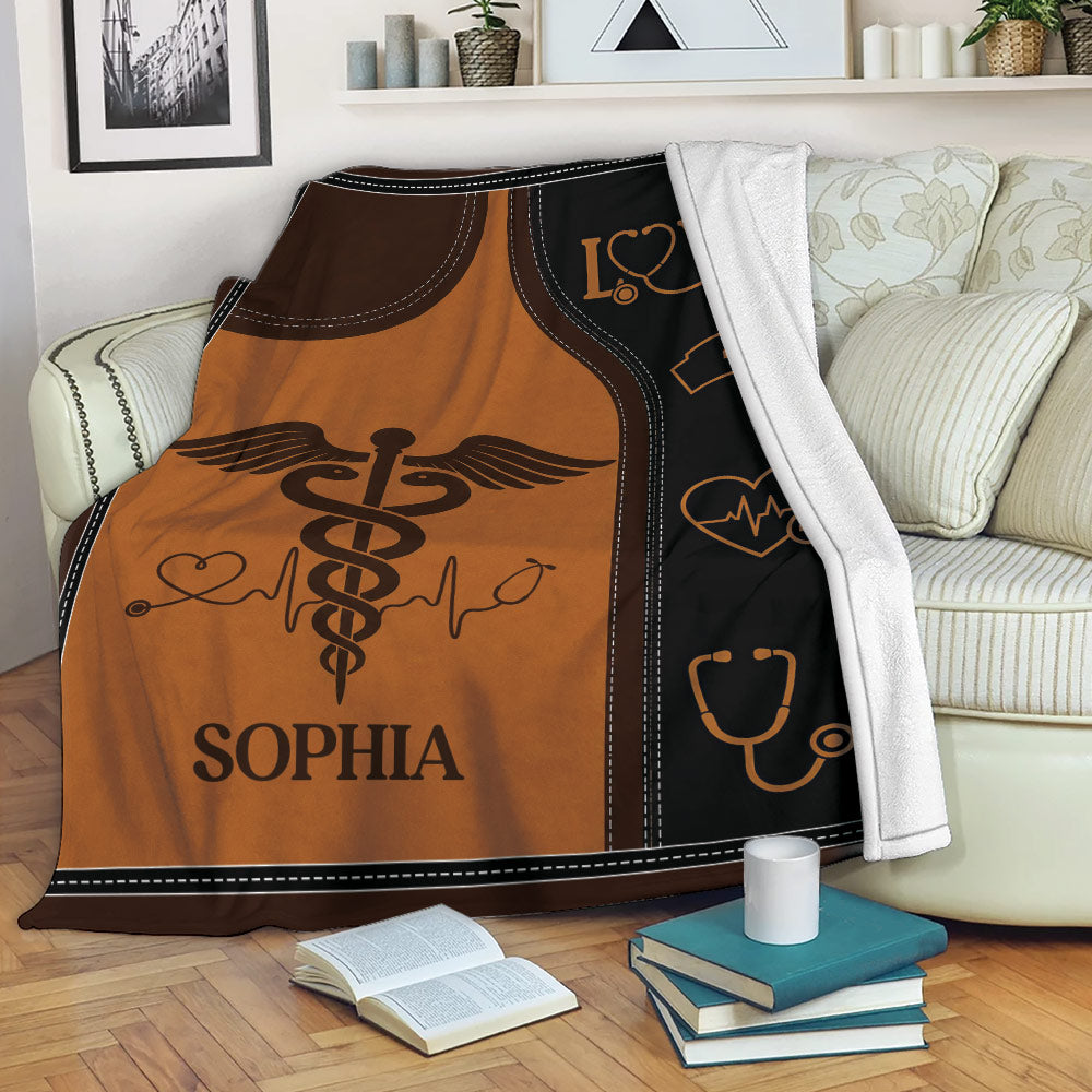 Nursing throw blanket displayed on a sofa with medical symbols and warm brown artwork