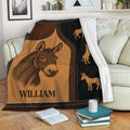 Donkey throw blanket displayed on a sofa with rustic brown and black artwork