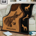 Rustic donkey throw blanket draped over a couch with illustrated donkey designs