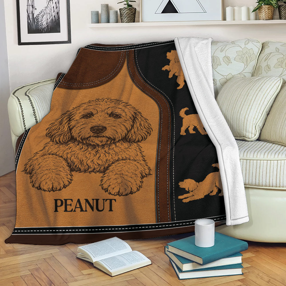 Labradoodle blanket displayed on a sofa with a cozy rustic dog-themed artwork