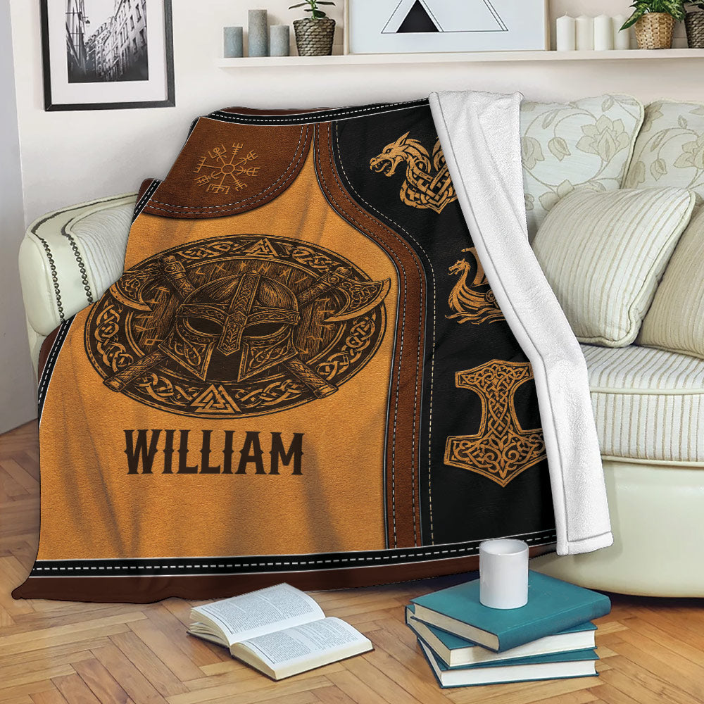 Viking throw blanket draped over a sofa with Norse helmet, dragon, longship, and knotwork design