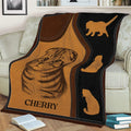 Scottish Fold cat blanket draped over a couch, featuring warm brown and black artwork