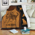 Bengal Cat Blanket draped over a sofa with warm brown and black artwork