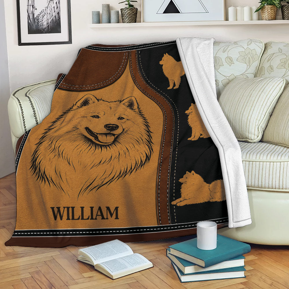 Samoyed blanket draped over a sofa with a large smiling dog portrait and smaller dog silhouettes