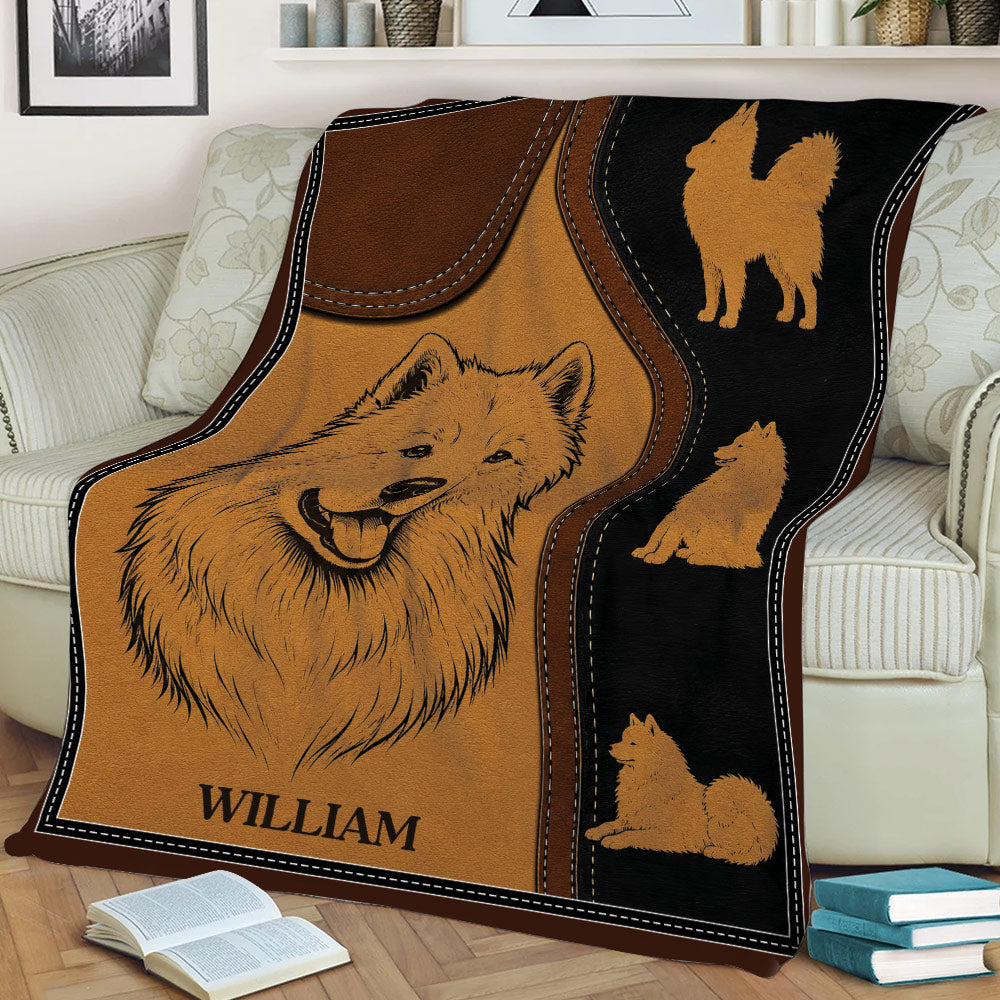 Samoyed throw blanket styled on a couch with portrait artwork and multiple dog illustrations