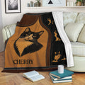 Tuxedo cat blanket displayed on a sofa with vintage cat artwork and cozy living room styling