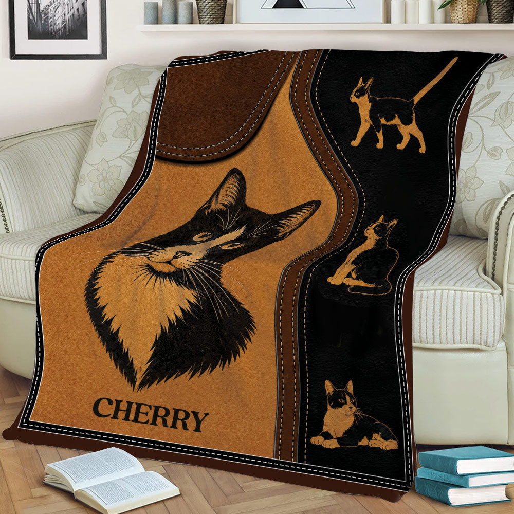 Black and white tuxedo cat throw blanket draped over a sofa with vintage illustrated cat details
